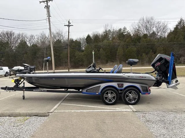 Slide: The Image of 2023 Ranger Z521R bass boat on trailer, parked outdoors, side view. - 17