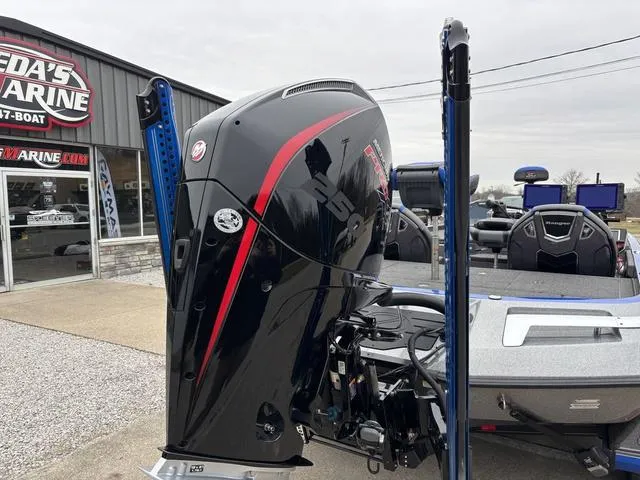 Slide: The Image of 2023 Ranger Z521R boat with powerful outboard motor, displayed at a marine dealership. - 2