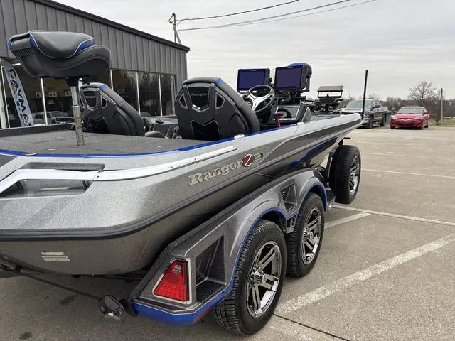 Slide: The Image of 2023 Ranger Z521R boat in parking lot, featuring dual consoles and modern design. - 4