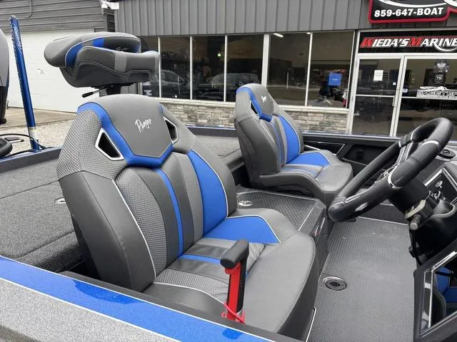 Slide: The Image of 2023 Ranger Z521R boat interior with blue and gray seats, steering wheel, and console. - 7