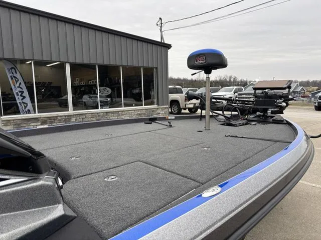 Slide: The Image of 2023 Ranger Z521R boat deck with fishing equipment, parked outside a showroom. - 8
