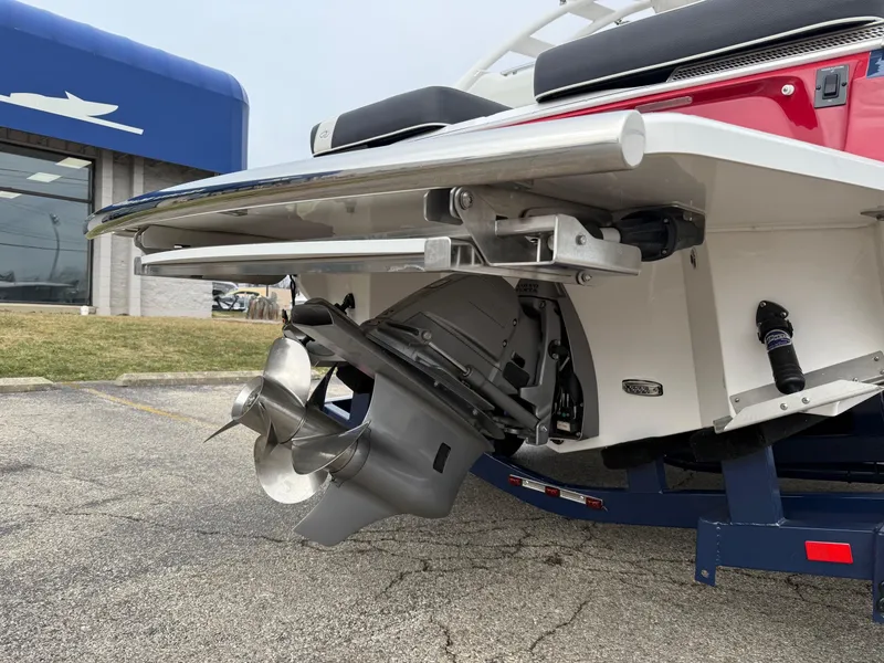 Slide: The Image of 2023 Regal LS6 boat stern with dual propeller system in a marina setting. - 1