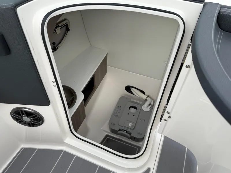 Slide: The Image of 2023 Regal LS6 boat interior with compact toilet and storage area. - 3