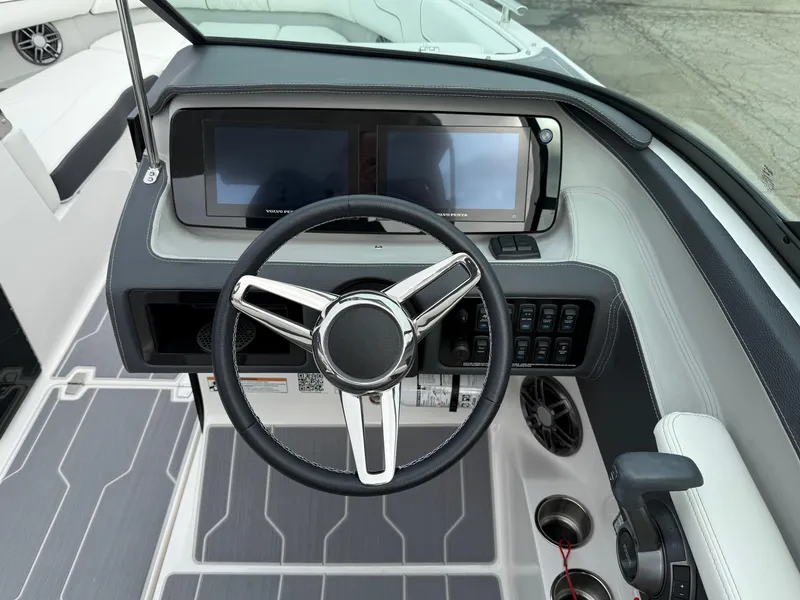 Slide: The Image of 2023 Regal LS6 boat dashboard with dual screens and modern steering wheel. - 5