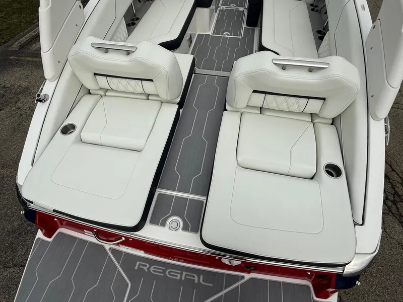 Slide: The Image of 2023 Regal LS6 boat interior with white leather seating and sleek design. - 8