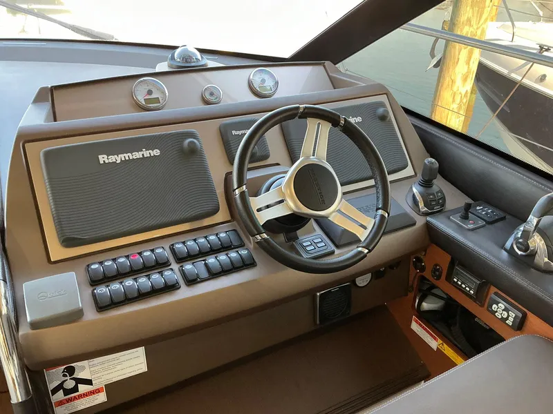Slide: The Image of Helm of 2015 Prestige 500 yacht with Raymarine navigation system and modern controls. - 12