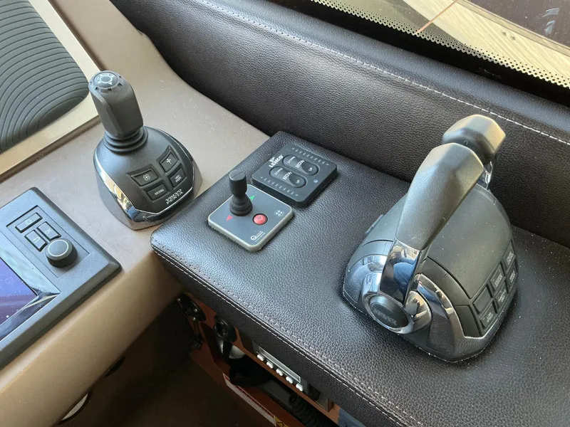 Slide: The Image of Control panel of a 2015 Prestige 500 yacht with joysticks and buttons. - 13