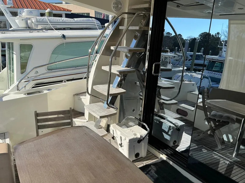 Slide: The Image of Luxurious 2015 Prestige 500 yacht interior with spiral staircase and outdoor seating area. - 15