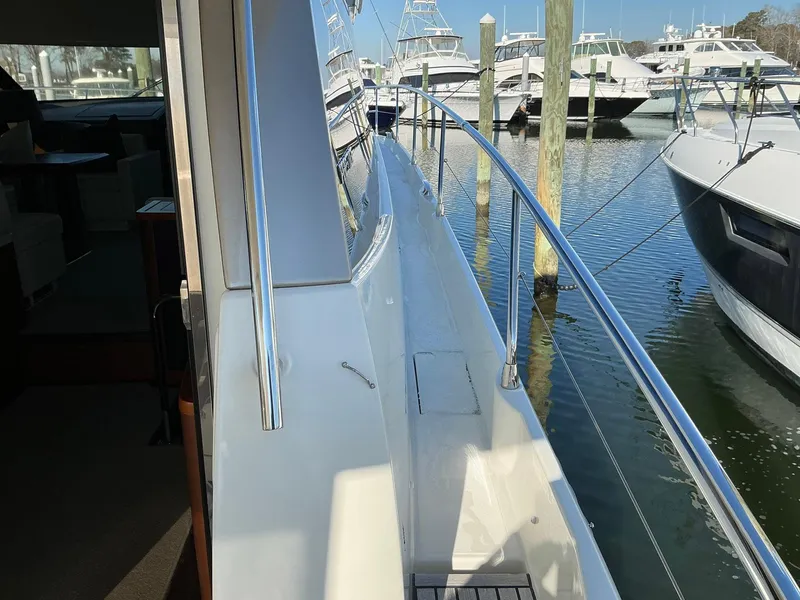 Slide: The Image of Side deck view of a 2015 Prestige 500 yacht docked at a marina. - 17