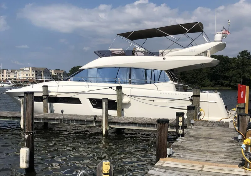 Slide: The Image of Luxury 2015 Prestige 500 yacht docked at a marina under a clear sky. - 2