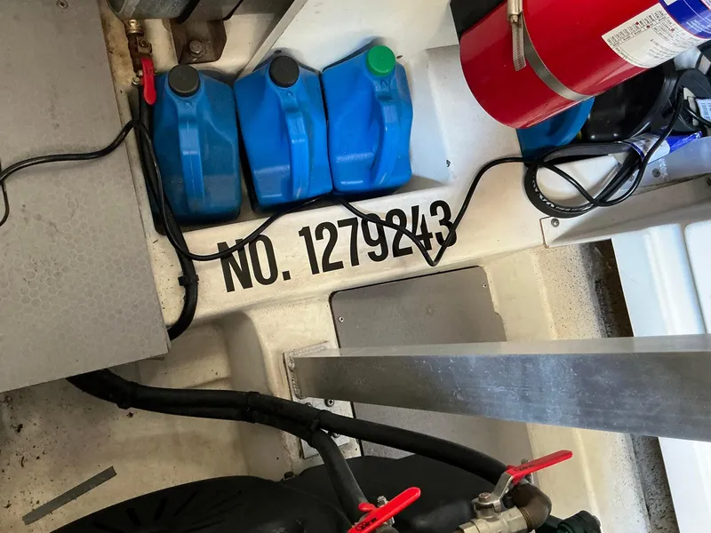 Slide: The Image of Engine room of 2015 Prestige 500 with fire extinguisher and blue containers. - 24