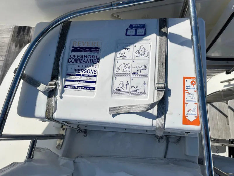 Slide: The Image of Liferaft container on a 2015 Prestige 500 yacht, featuring safety instructions and secure straps. - 26
