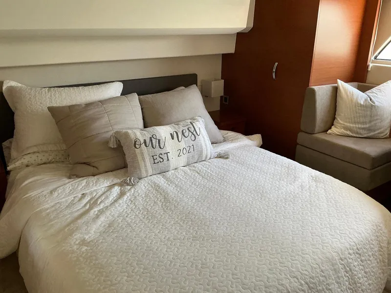 Slide: The Image of Cozy bedroom in a 2015 Prestige 500 yacht with pillows and "Our Nest" cushion. - 27
