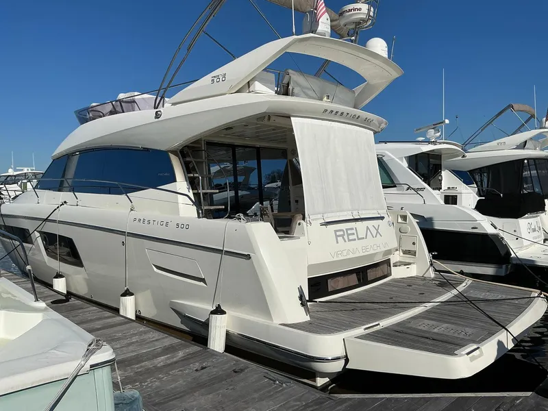 Slide: The Image of Luxury 2015 Prestige 500 yacht docked, featuring sleek design and spacious deck. - 3