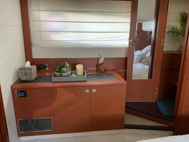 Slide: The Image of Luxurious interior of a 2015 Prestige 500 yacht, featuring elegant wood cabinetry and decor. - 30