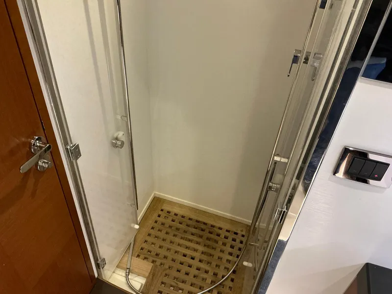 Slide: The Image of Compact shower area with glass door and wooden floor in a 2015 Prestige 500 yacht. - 33