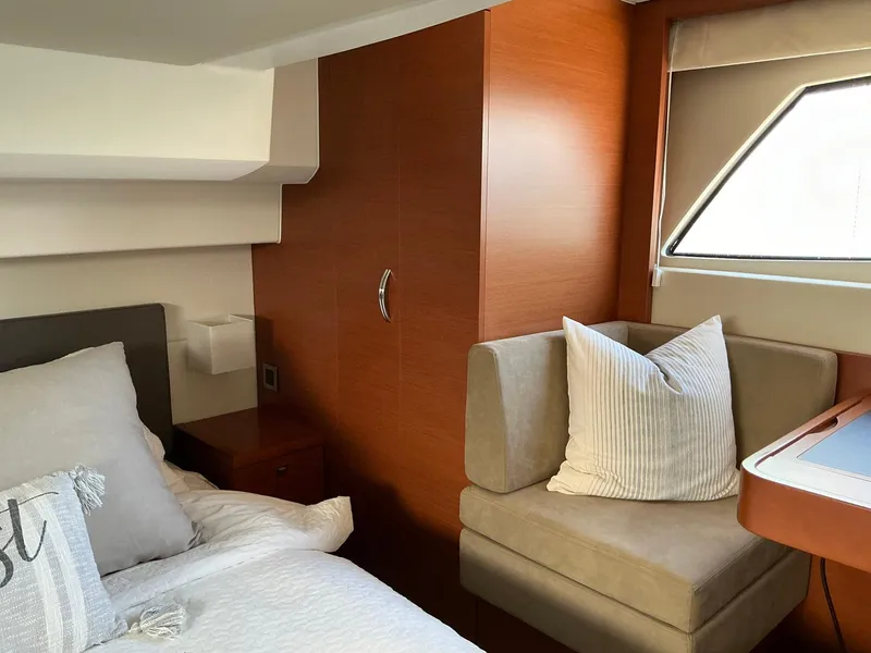 Slide: The Image of Luxurious cabin interior of 2015 Prestige 500 yacht with cozy bed and seating area. - 35