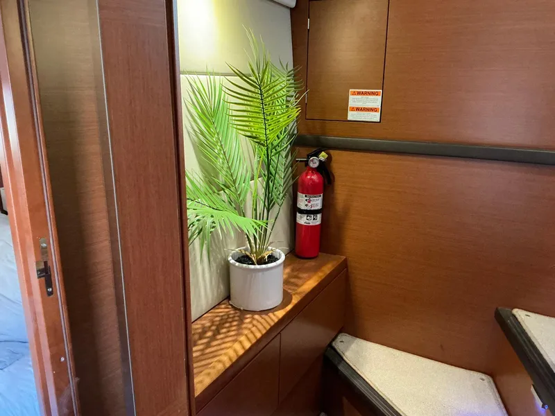 Slide: The Image of Potted plant and fire extinguisher on wooden shelf inside 2015 Prestige 500 yacht interior. - 36