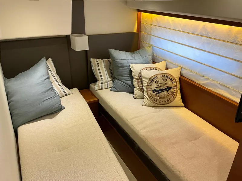 Slide: The Image of Cozy cabin interior of a 2015 Prestige 500 yacht with twin beds and decorative pillows. - 38