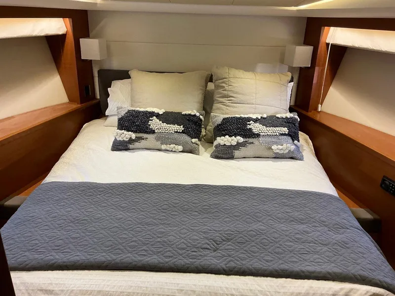 Slide: The Image of Luxurious bedroom interior of 2015 Prestige 500 yacht with elegant bedding and wooden accents. - 39