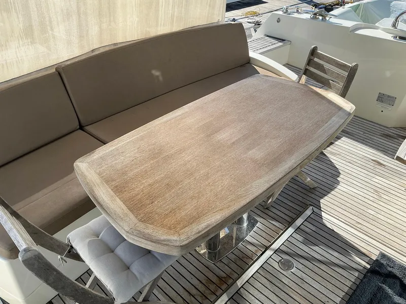 Slide: The Image of Luxury yacht deck with wooden table and cushioned seating, Prestige 500, 2015 model. - 47