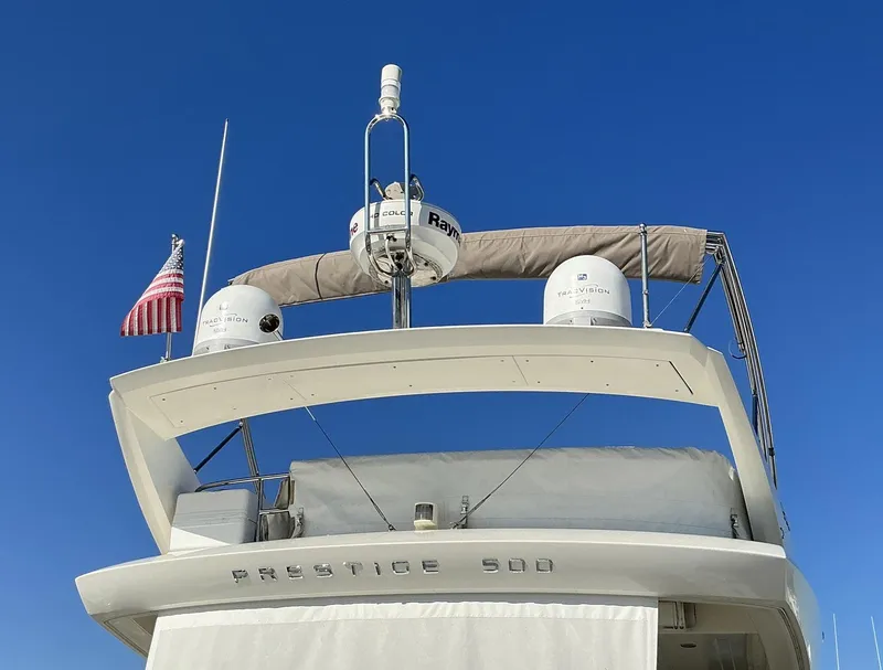 Slide: The Image of 2015 Prestige 500 yacht with radar equipment and American flag against clear blue sky. - 7