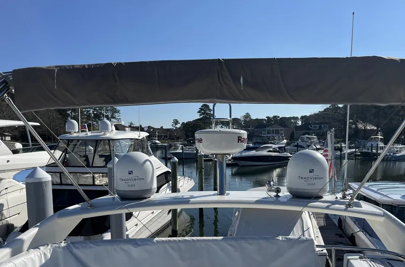 Slide: The Image of 2015 Prestige 500 yacht docked at marina, featuring radar and satellite equipment. - 9