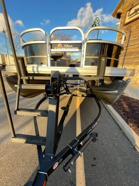 Slide: The Image of 2022 Sun Tracker BB16 boat on trailer, parked outdoors under a clear sky. - 4