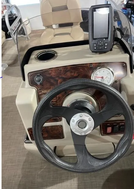 Slide: The Image of 2022 Sun Tracker BB16 boat dashboard with steering wheel and navigation system. - 5