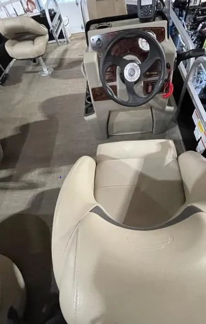 Slide: The Image of 2022 Sun Tracker BB16 boat interior with steering wheel and beige seating. - 6