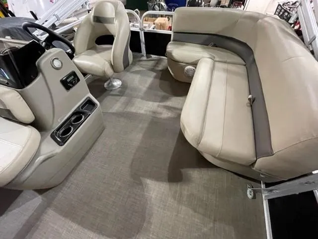 Slide: The Image of Interior of 2022 Sun Tracker BB16 boat with beige seating and steering console. - 8