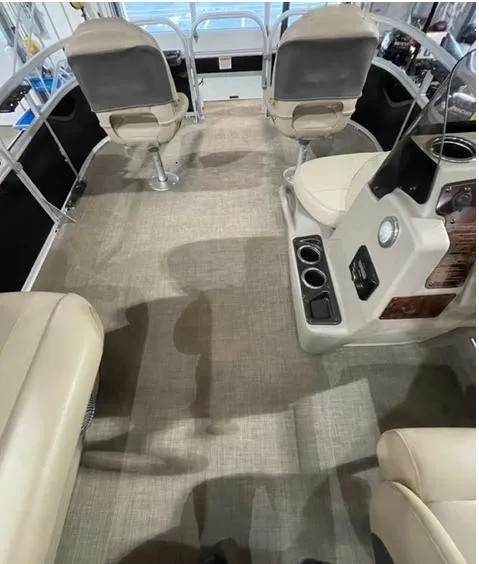 Slide: The Image of 2022 Sun Tracker BB16 boat interior with beige seating and modern dashboard. - 9