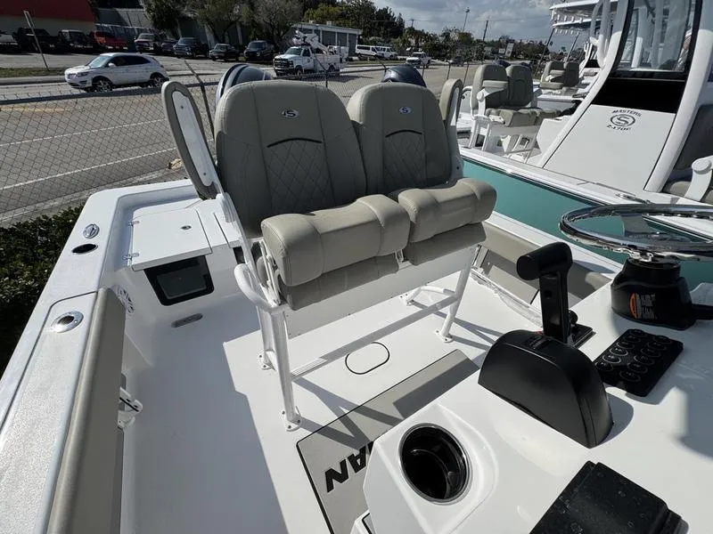 Slide: The Image of 2025 Sportsman Masters 227 boat interior with dual seats and steering console. - 13