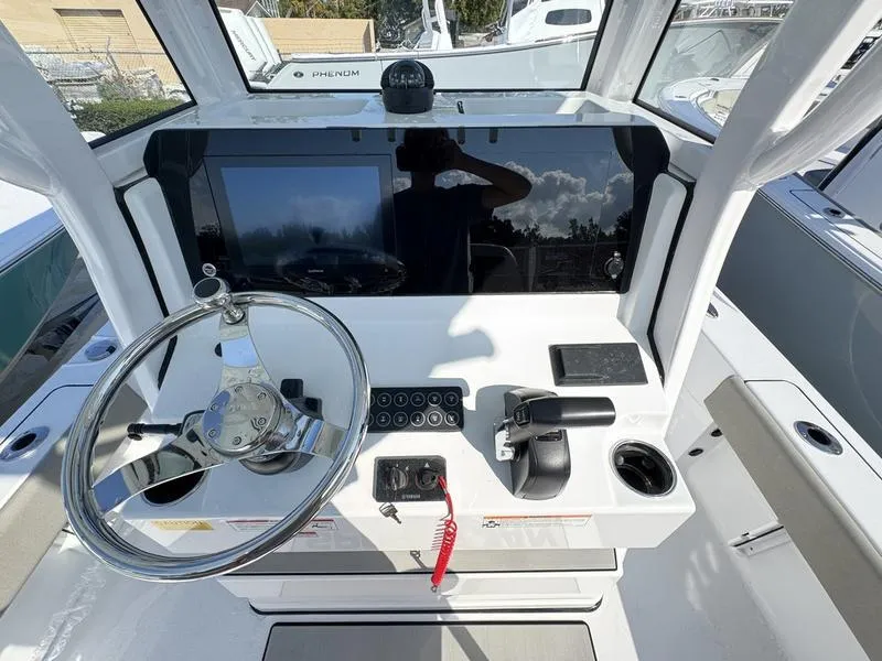 Slide: The Image of 2025 Sportsman Masters 227 boat dashboard with steering wheel and control panel. - 18