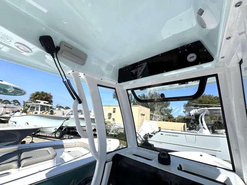 Slide: The Image of Interior view of a 2025 Sportsman Masters 227 boat, showcasing modern controls and seating. - 20