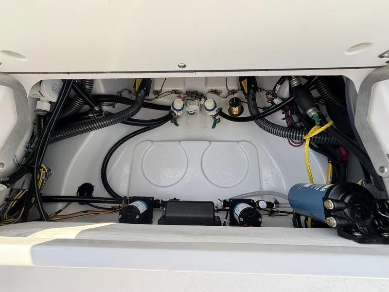 Slide: The Image of Engine compartment of a 2025 Sportsman Masters 227 boat, showcasing wiring and components. - 22