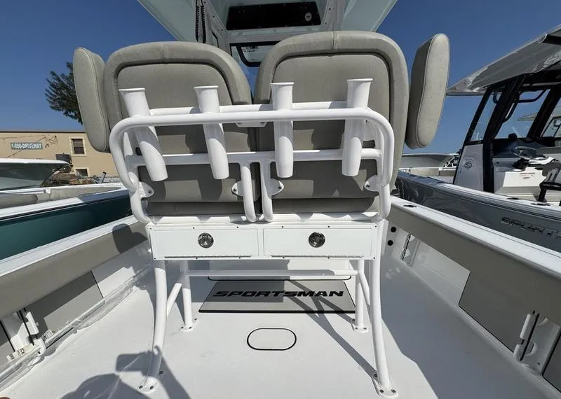 Slide: The Image of 2025 Sportsman Masters 227 boat interior with dual seats and rod holders. - 24