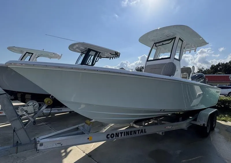 Slide: The Image of 2025 Sportsman Masters 227 boat on trailer under clear sky. - 28