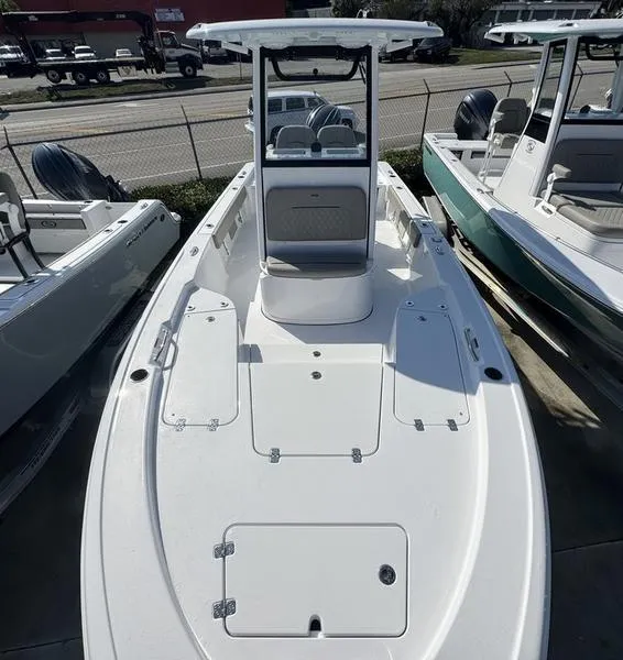 Slide: The Image of 2025 Sportsman Masters 227 boat, white deck, center console, docked in a marina. - 4