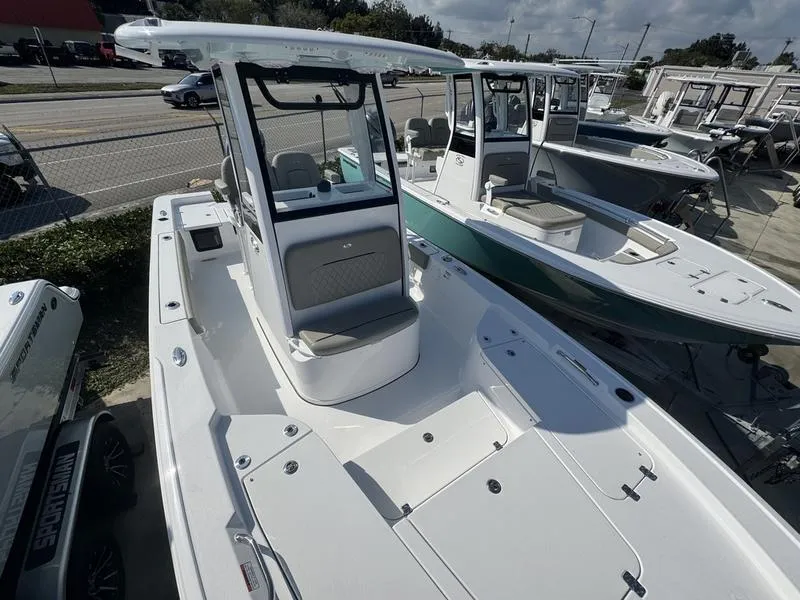 Slide: The Image of 2025 Sportsman Masters 227 boat displayed in a showroom, showcasing sleek design and spacious deck. - 5