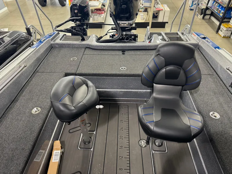 Slide: The Image of 2025 Nitro ZV21 boat interior with two black seats and a measuring ruler on the floor. - 12