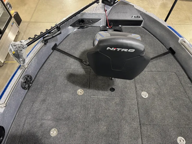 Slide: The Image of 2025 Nitro ZV21 boat interior with seating and fishing rod holders. - 19