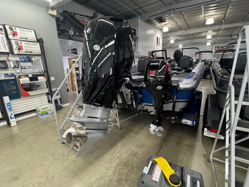 Slide: The Image of 2025 Nitro ZV21 boat with powerful outboard motors in a showroom setting. - 3