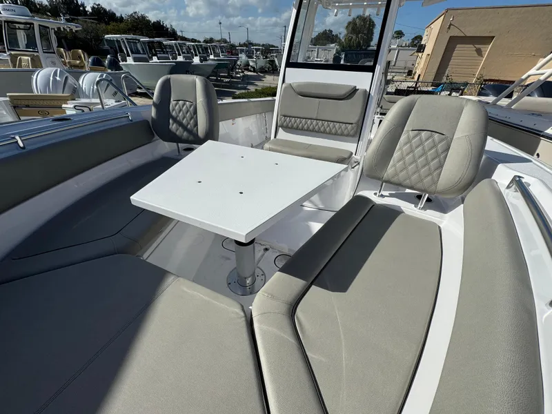 Slide: The Image of 2025 Sportsman Heritage 261 boat interior with seating and table, showcasing modern design. - 11