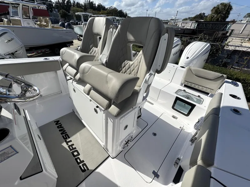 Slide: The Image of 2025 Sportsman Heritage 261 boat interior with cushioned seating and modern design. - 13