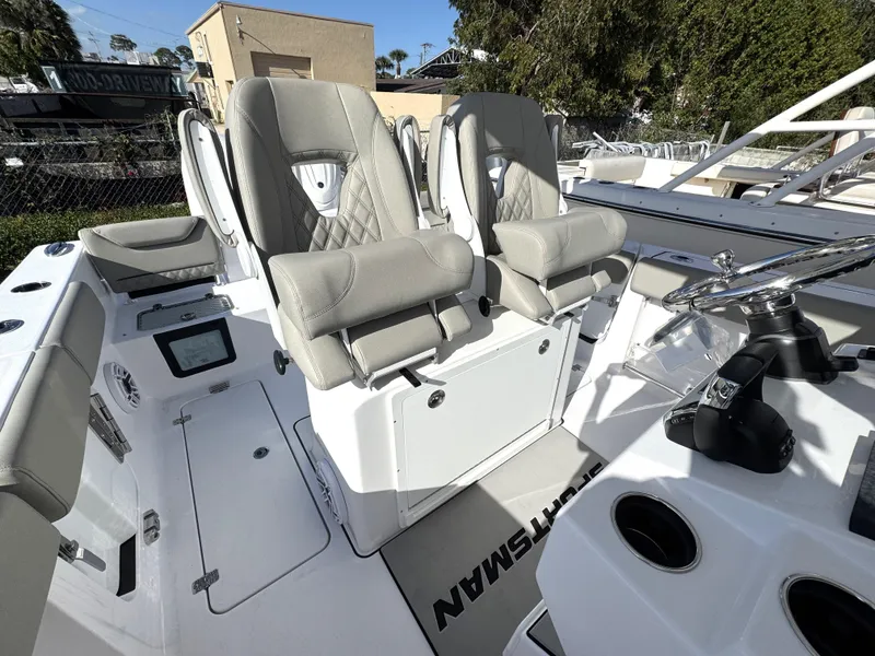Slide: The Image of 2025 Sportsman Heritage 261 boat interior with luxurious seating and modern controls. - 14