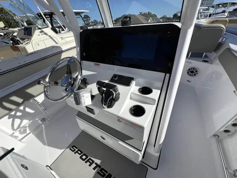 Slide: The Image of 2025 Sportsman Heritage 261 boat cockpit with steering wheel and control panel. - 17