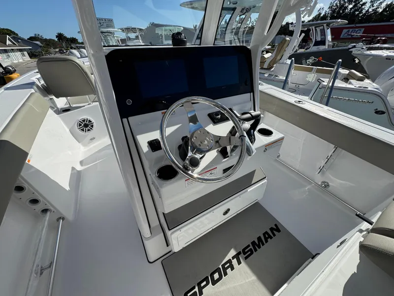 Slide: The Image of 2025 Sportsman Heritage 261 boat cockpit with modern steering and dual screens. - 18