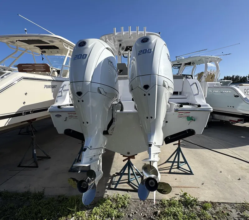 Slide: The Image of 2025 Sportsman Heritage 261 boat with twin 200 horsepower engines on display. - 2