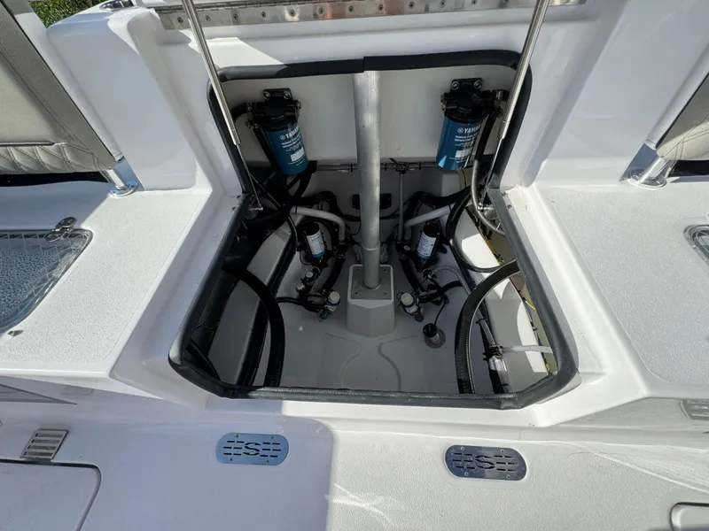 Slide: The Image of 2025 Sportsman Heritage 261 boat interior showing open hatch with mechanical components. - 21